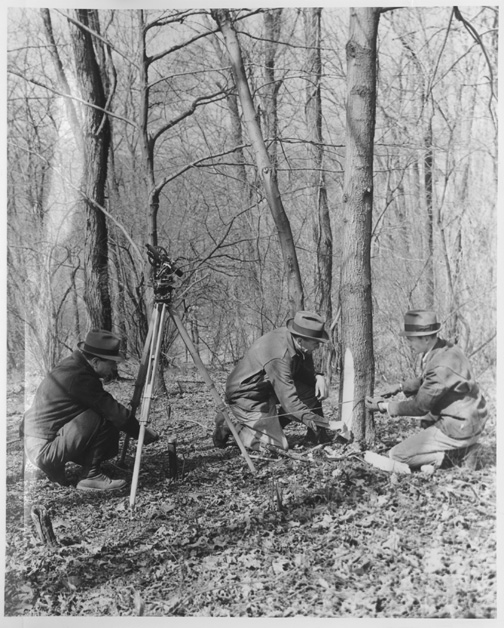 Bureau of Land Management surveyor's recording distance between monument (iron post) and tree.
